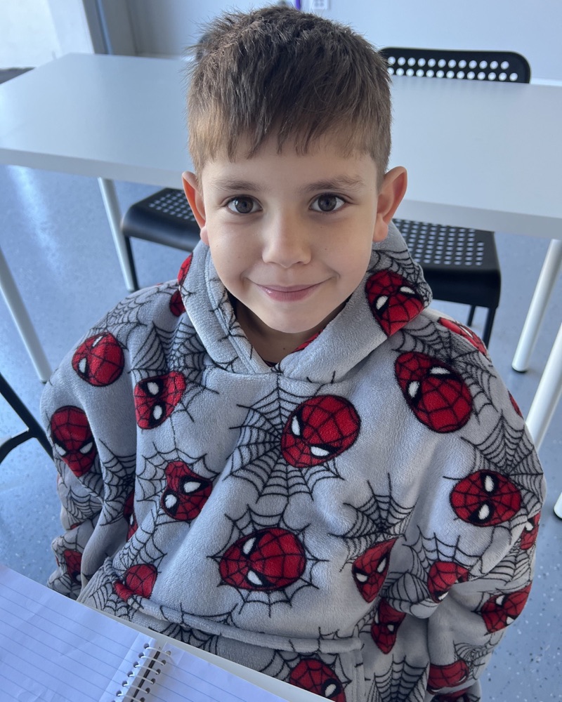 A smiling student ready to start his lesson